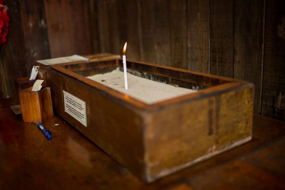 commemorative candle on sand from changi beach