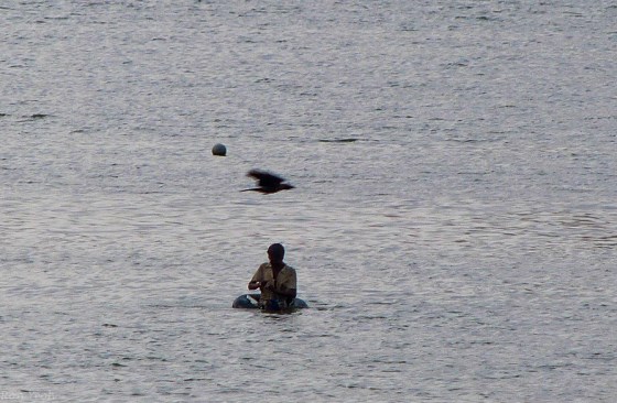 a lone fisherman in the lake..