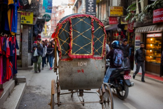 the street of Thamel are narrow and crowded and pedestrians share the road with vehicvles