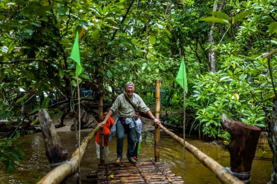 Ces lookind suitably embarrassed at being carried over the shallow river waters by our two porters...haha..the rest of us took off our shoes and waded over